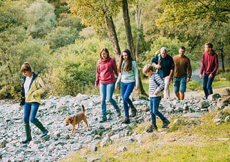 Family with children and grandparents hiking in the Lake District.