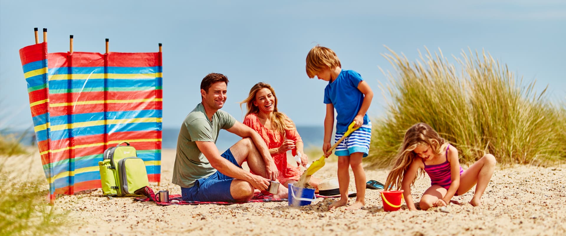 Family having fun in the sun on sandy beach