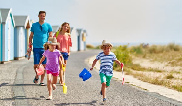Family walking to beach in summertime