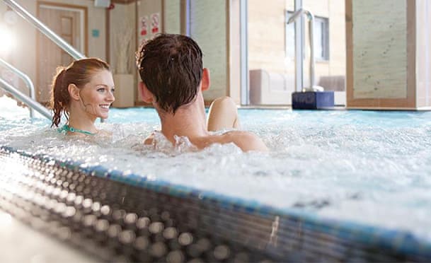 Couple enjoying bubbling Jacuzzi