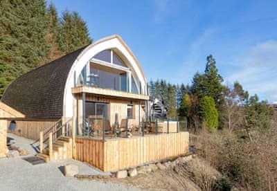 Scottish lodge exterior surrounded by woodland