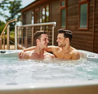 Couple enjoying the hot tub on a sunny day